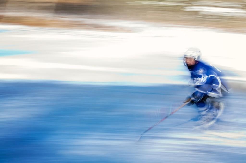 Hockey player in motion blur on the ice.